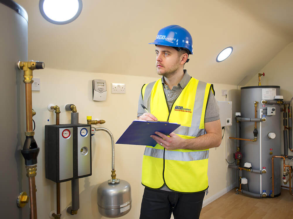 T.M.Services engineer inspecting a boiler